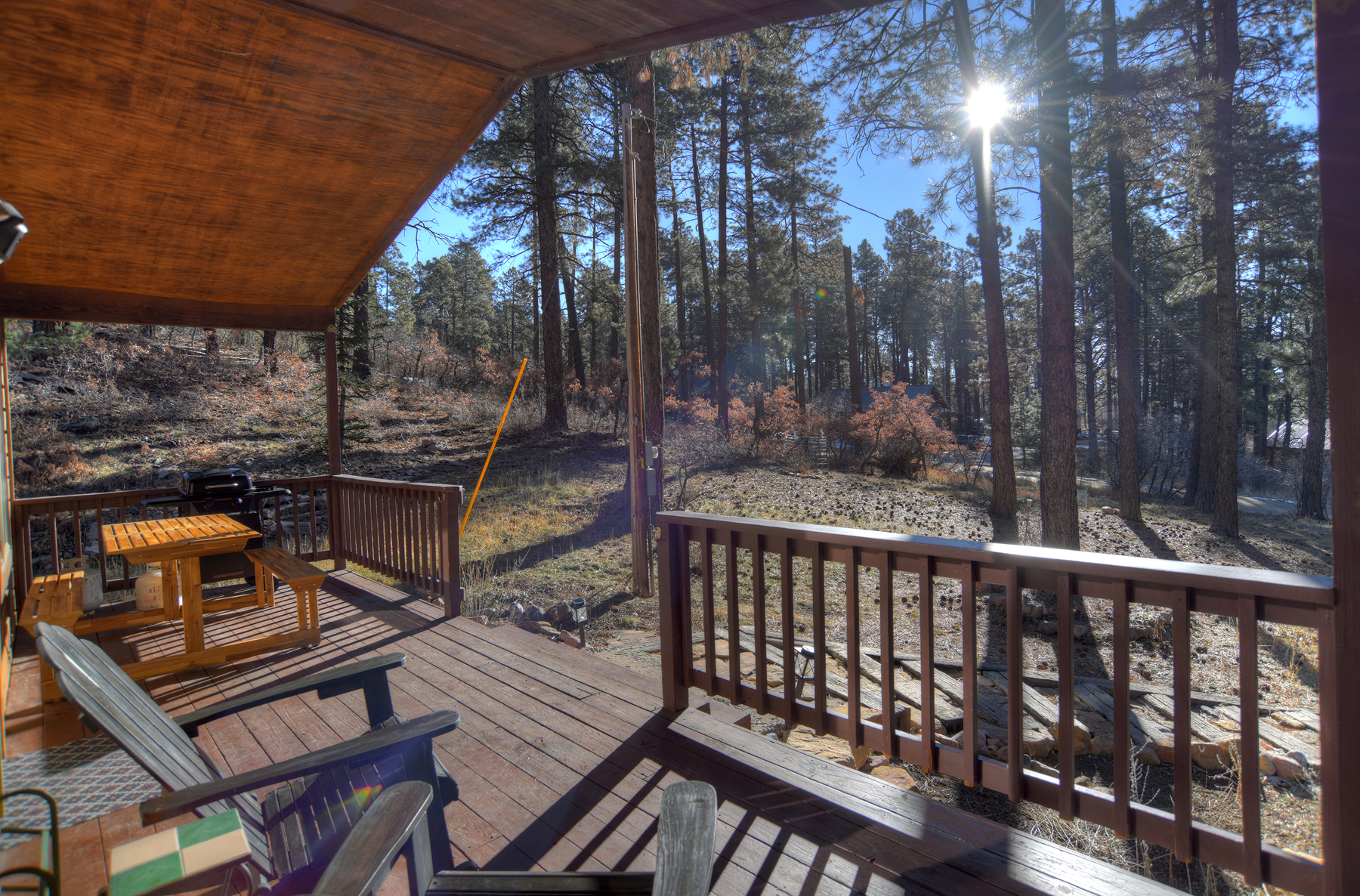 Private deck with outdoor seating among the towering pines – enjoy your morning coffee, grill dinner on the BBQ, or simply breathe in the fresh mountain air.