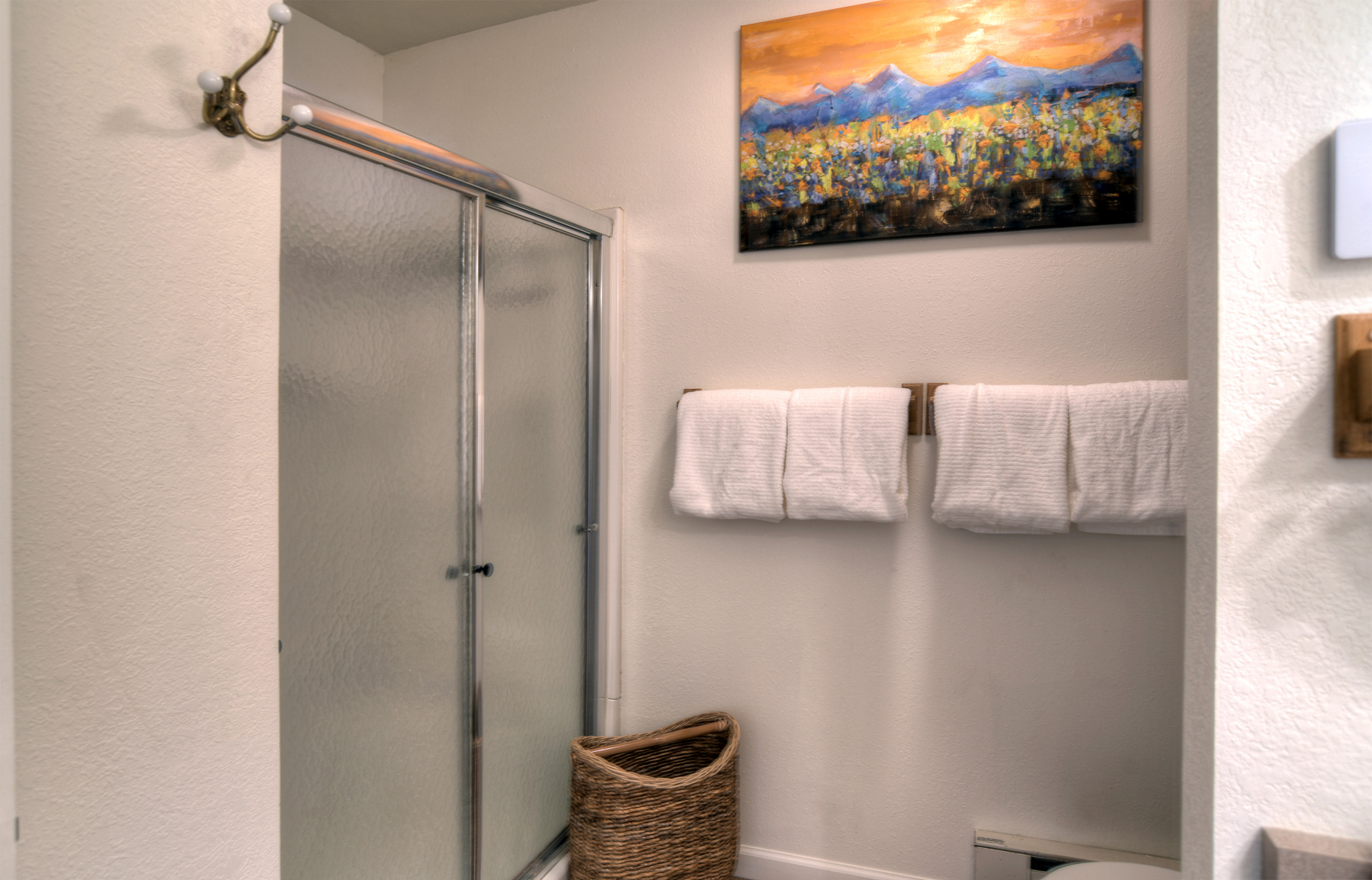 Clean bathroom with walk-in shower and modern amenities – fresh towels and essentials provided for your comfort.