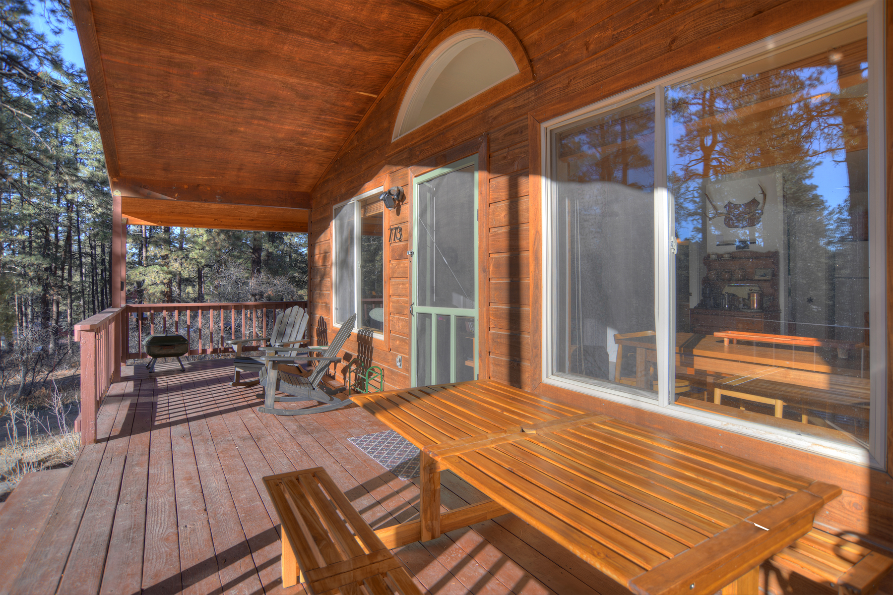 Deck with built-in seating overlooking the forest – a wonderful spot for enjoying nature and outdoor meals with your group.
