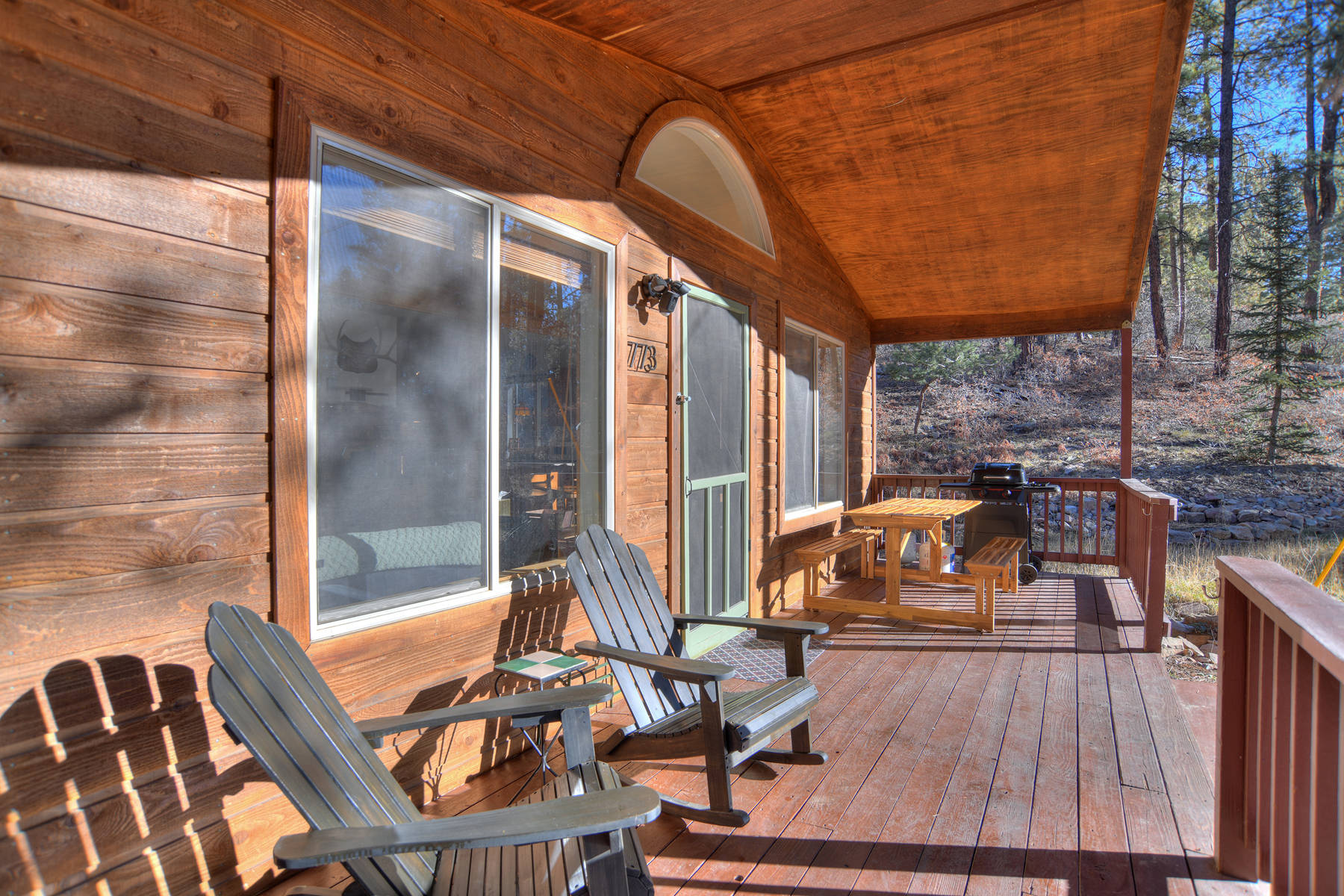 Spacious deck with Adirondack chairs and BBQ grill – the perfect spot to relax outdoors and soak in the peaceful mountain atmosphere.