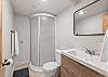 Full bathroom featuring a sleek walk-in shower.
