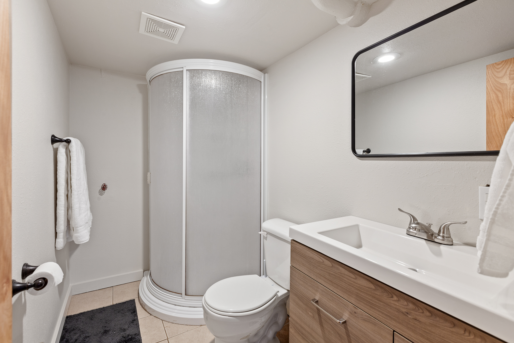 Full bathroom featuring a sleek walk-in shower.
