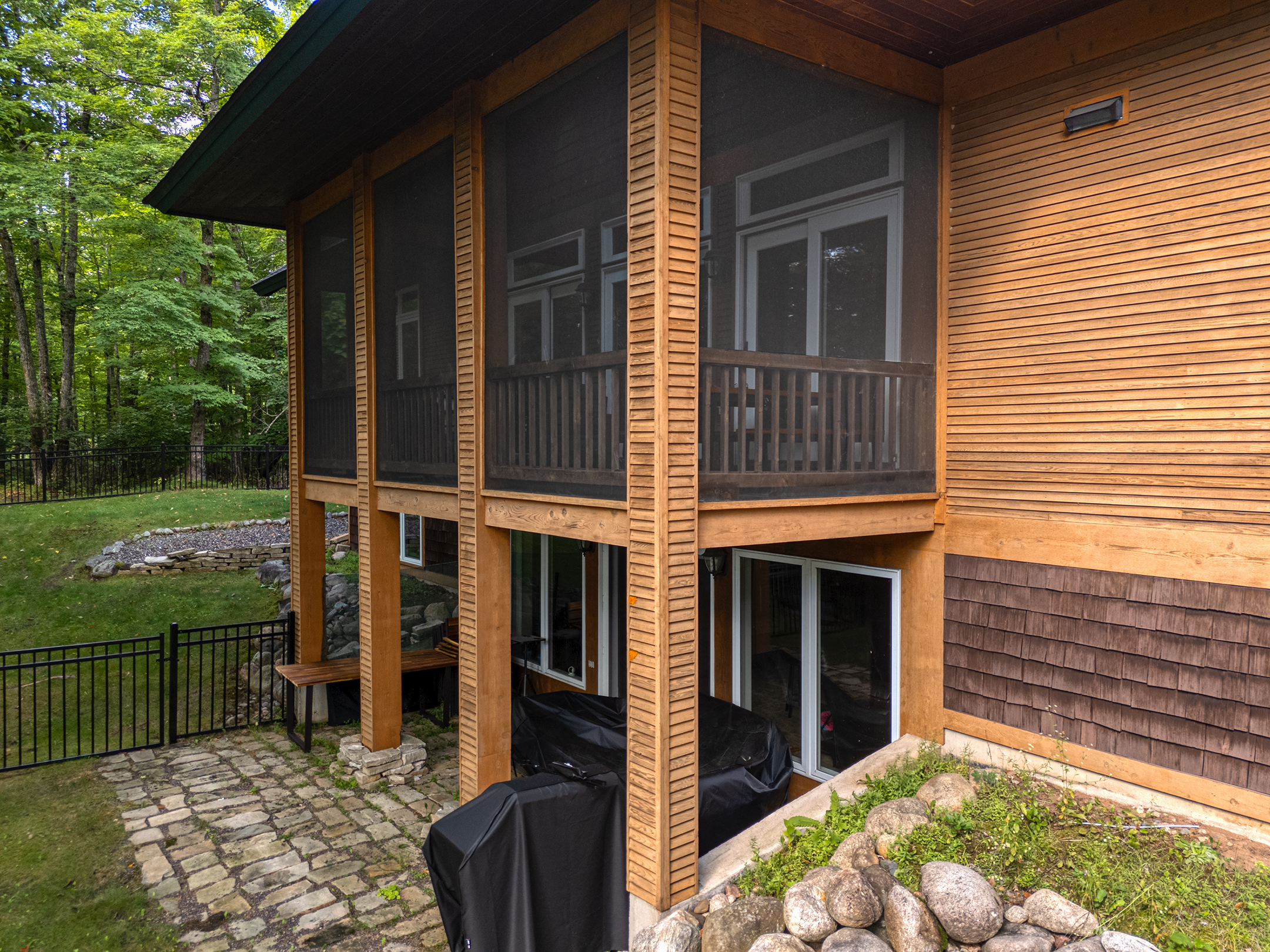 Beautiful lakefront home with natural wood siding and Northwoods charm – your peaceful retreat surrounded by nature''s beauty.