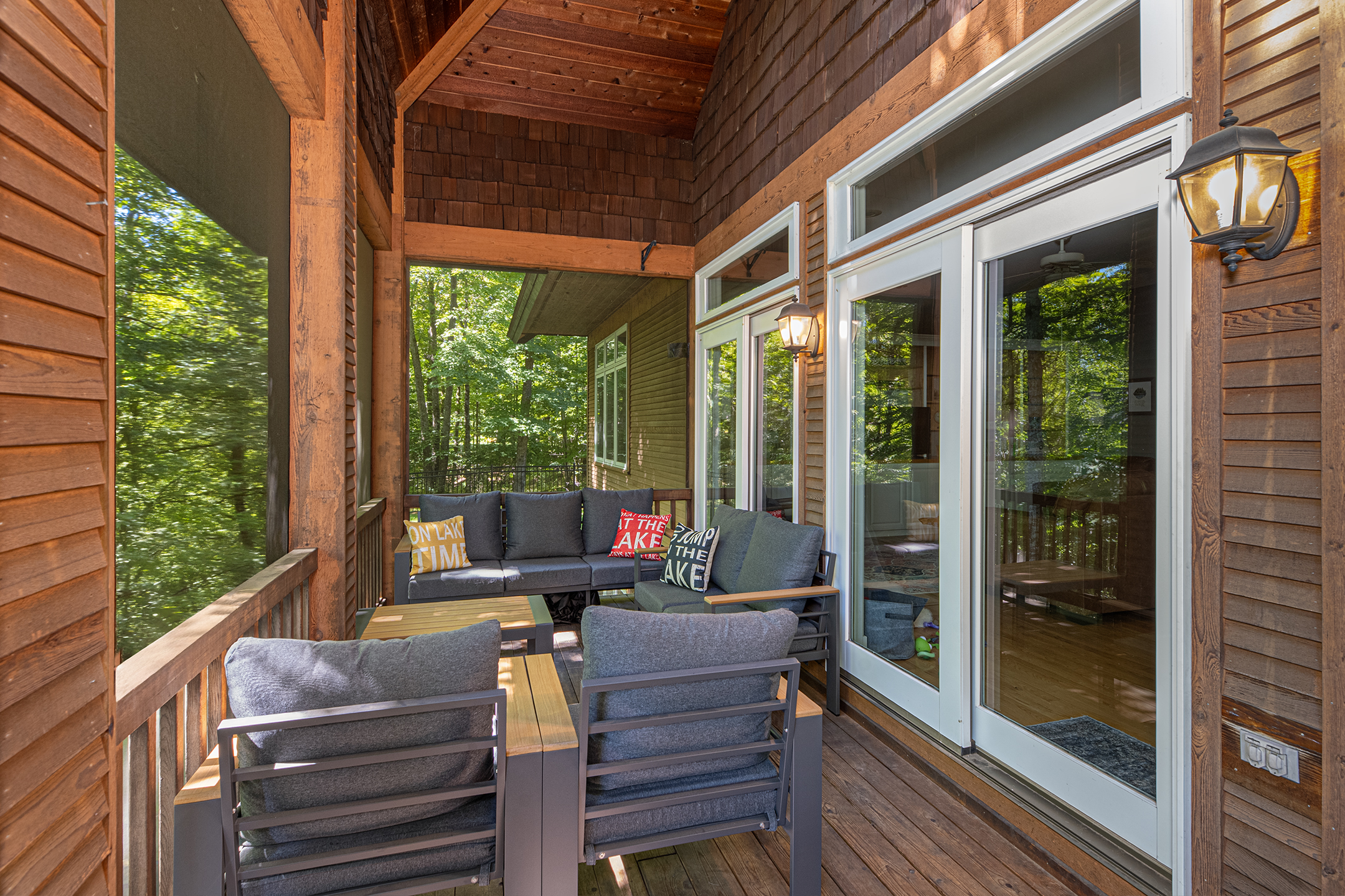 Inviting screened sunroom with comfortable furniture and stunning lake views – a favorite gathering spot for families to relax and reconnect.