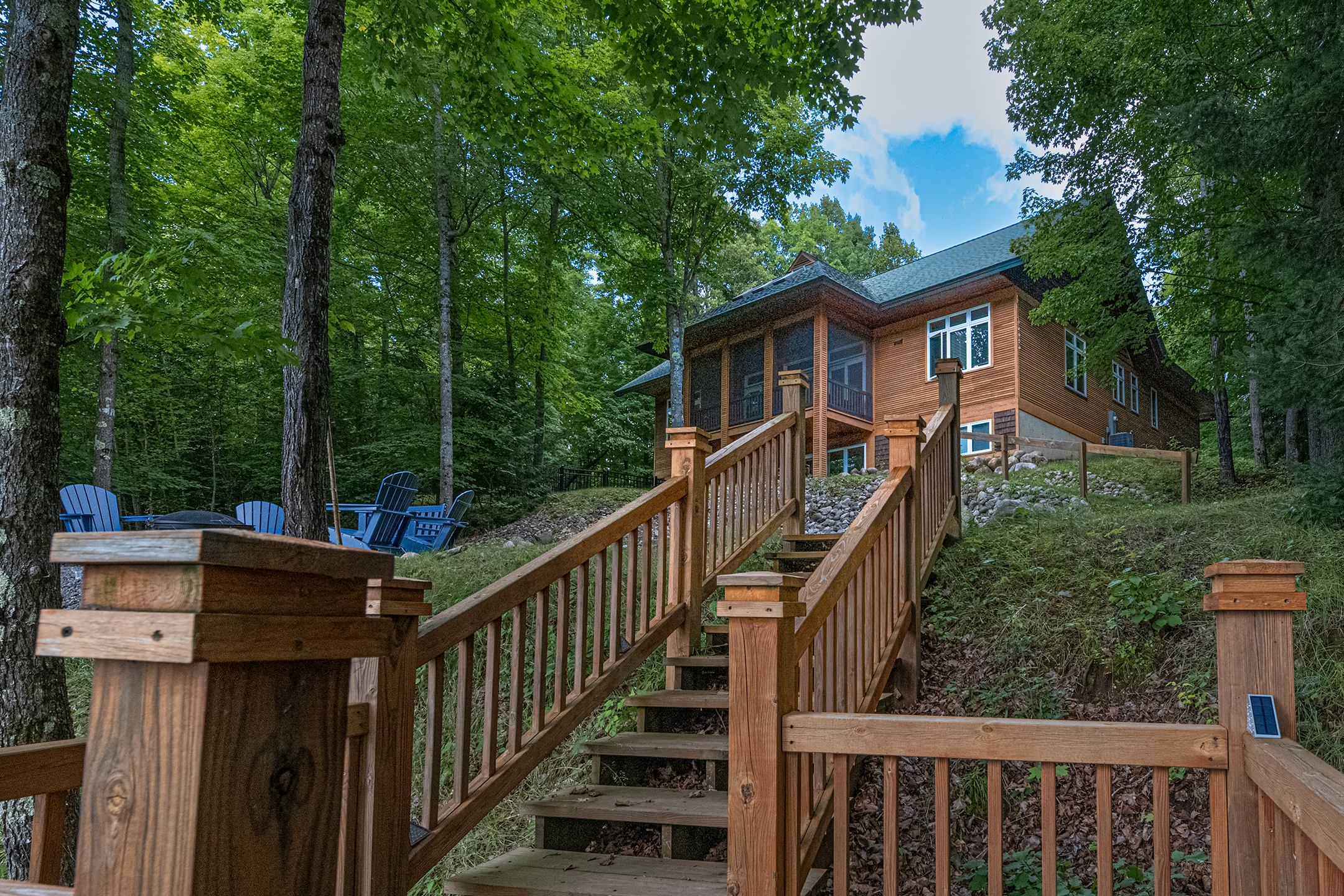 Peaceful waterfront view through towering pines – your secluded lakeside retreat surrounded by the beauty of Wisconsin''s Northwoods.