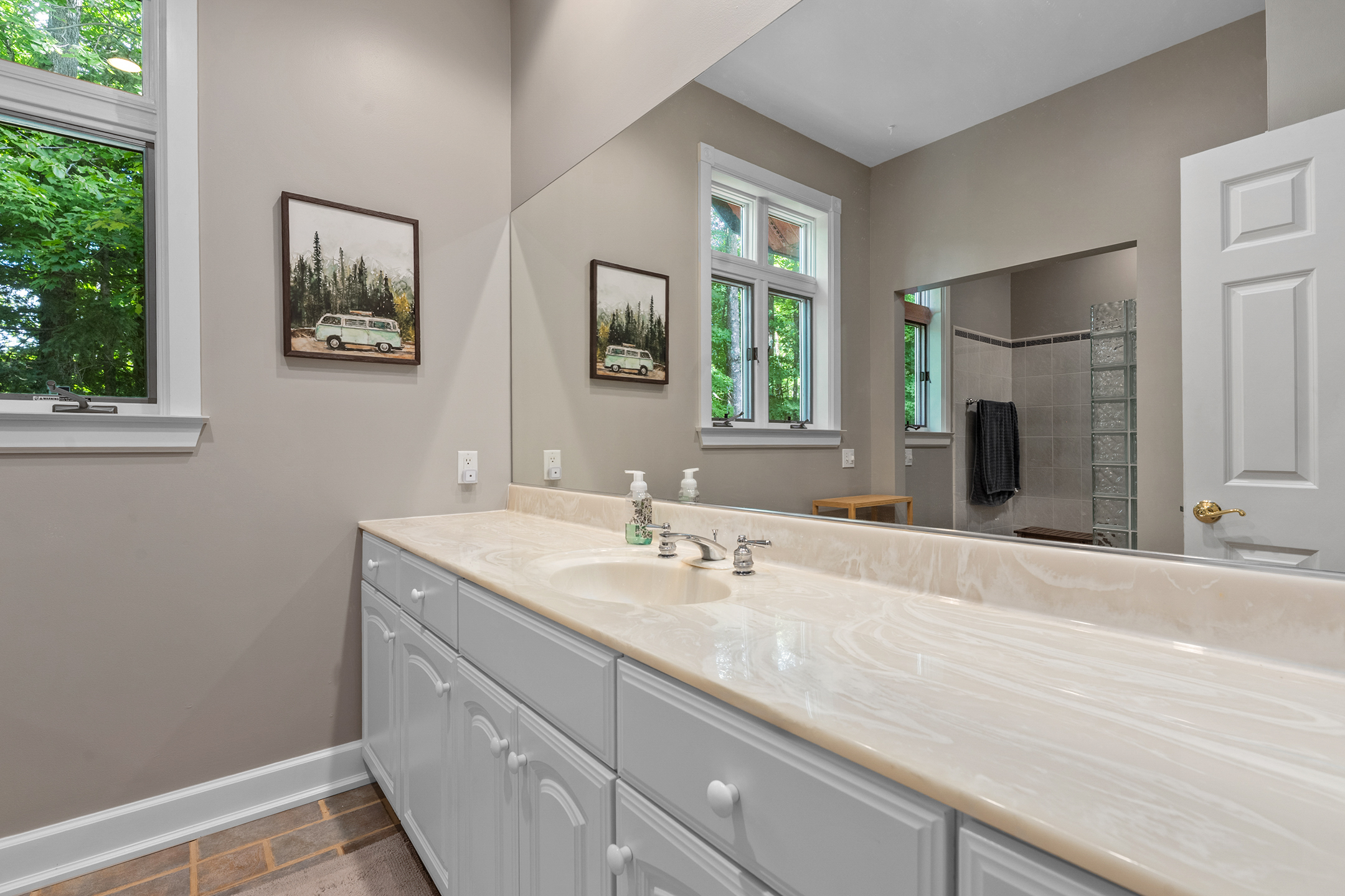 Modern bathroom with dual vanity and spacious design – featuring contemporary fixtures and plenty of storage for your convenience.