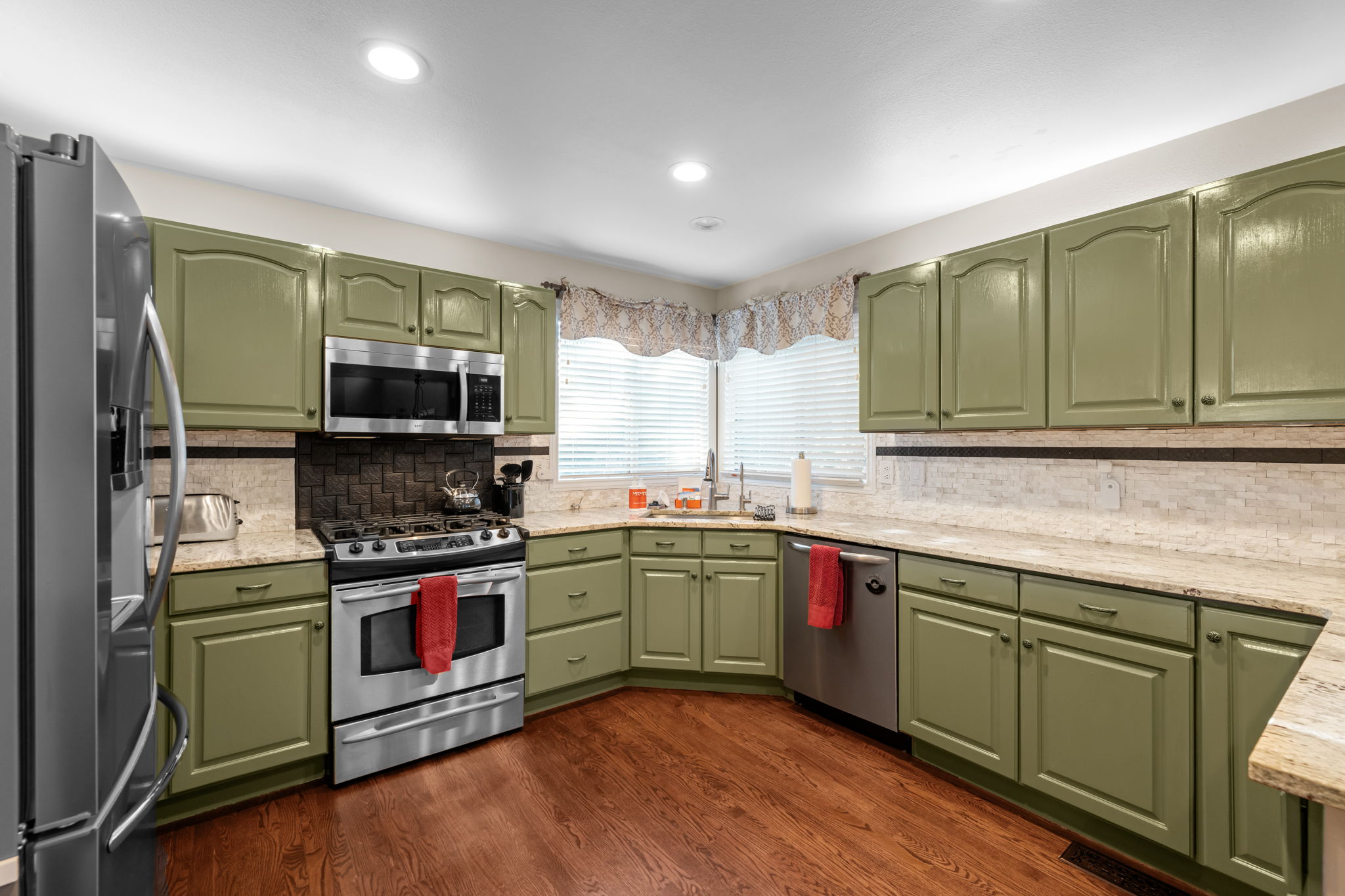 Bright kitchen with island seating and direct access to the dining area.Front exterior showcasing the two-story design and attached garage.