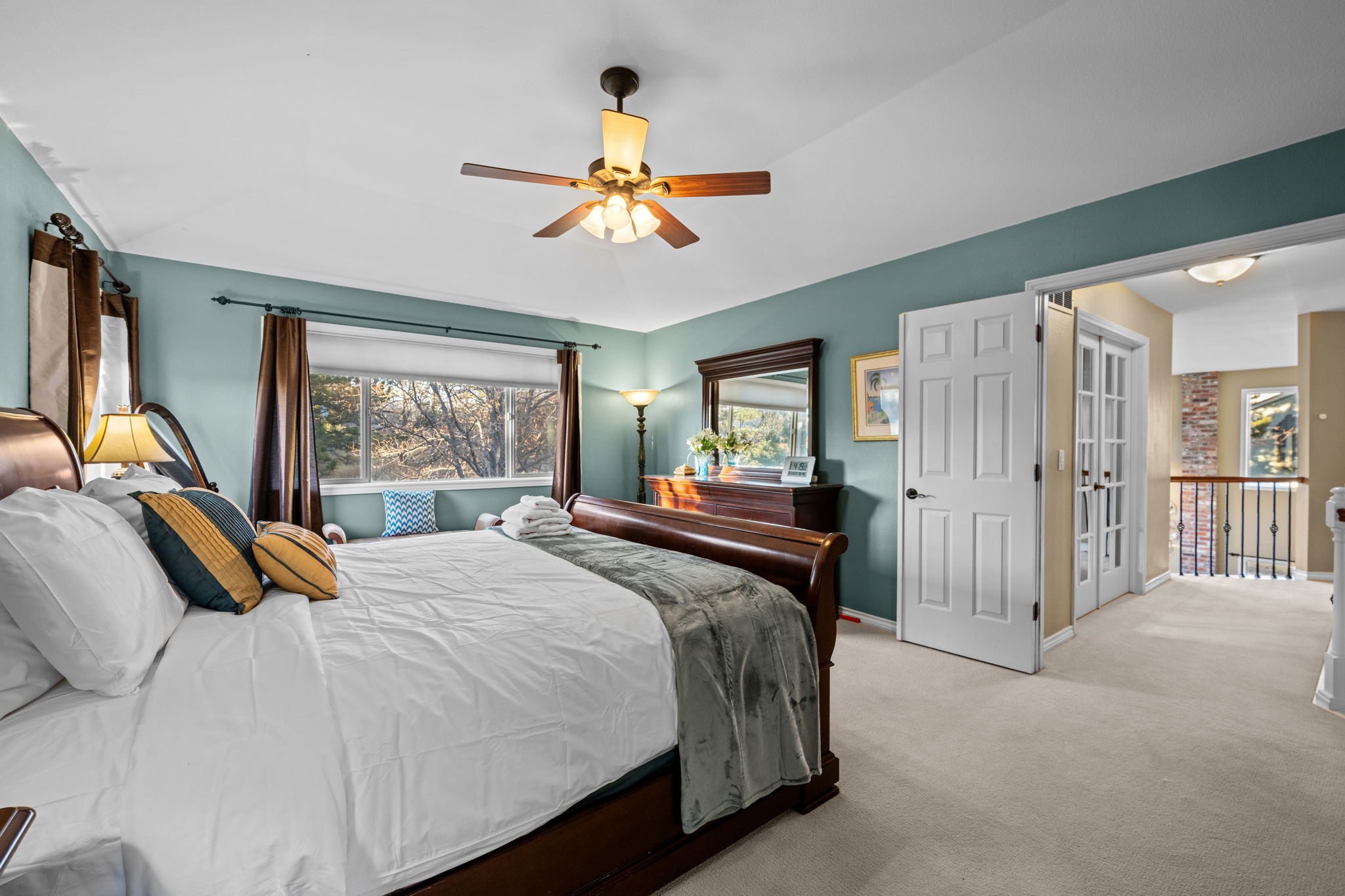 Serene primary suite with calming decor.