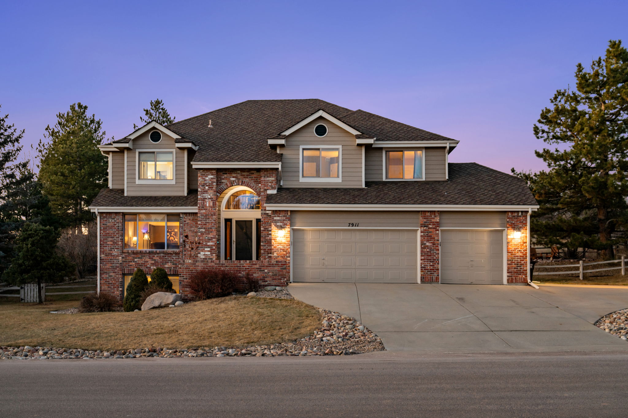 Charming exterior view of this inviting Parker retreat at duskNeighborhood street view showcasing the Lakeshore community setting