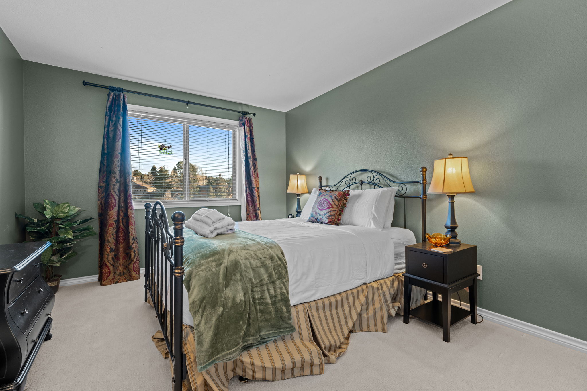 Cozy guest bedroom with ample natural light and closet storage.Dusk view of the home''s exterior with inviting outdoor lighting.