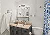 Full bathroom with shower/tub combo.