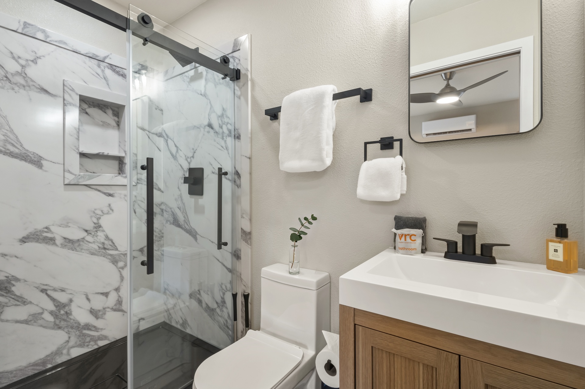 Full bathroom featuring a sleek walk-in shower.
