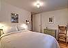 Third bedroom on the main level featuring a queen bed. 
