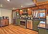 Fully equipped kitchen with stainless steel appliances and open-concept living.
