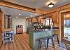 Open kitchen with stainless steel appliances and coffee bar.