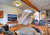 Living room with Smart TV.  The stairs will take you upstairs to the king bedroom and second living room.  