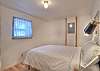 Third bedroom on the main level featuring a queen bed. 