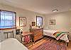 Fourth bedroom on the main level featuring two twin beds.