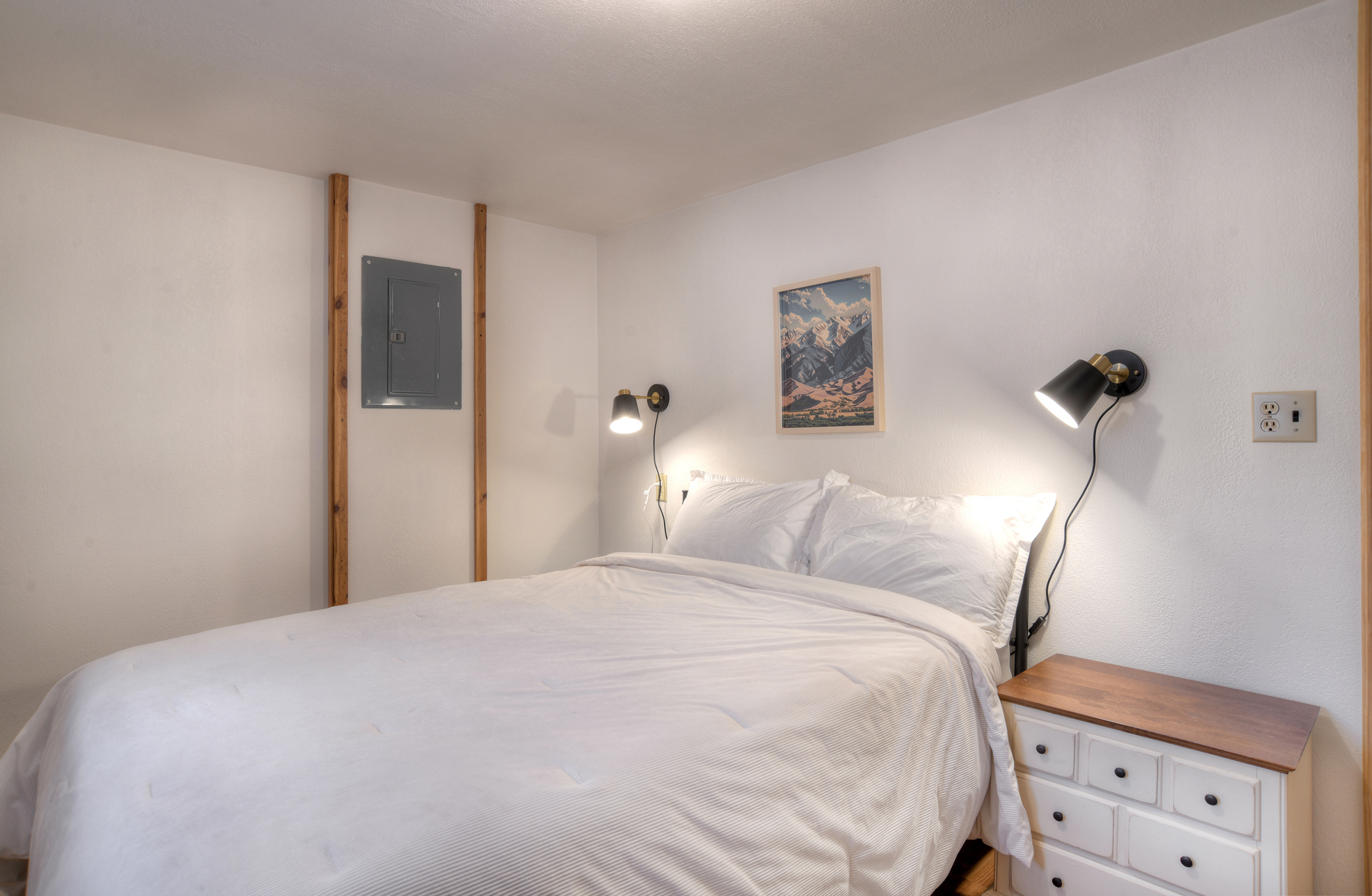 Third bedroom on the main level featuring a queen bed. 