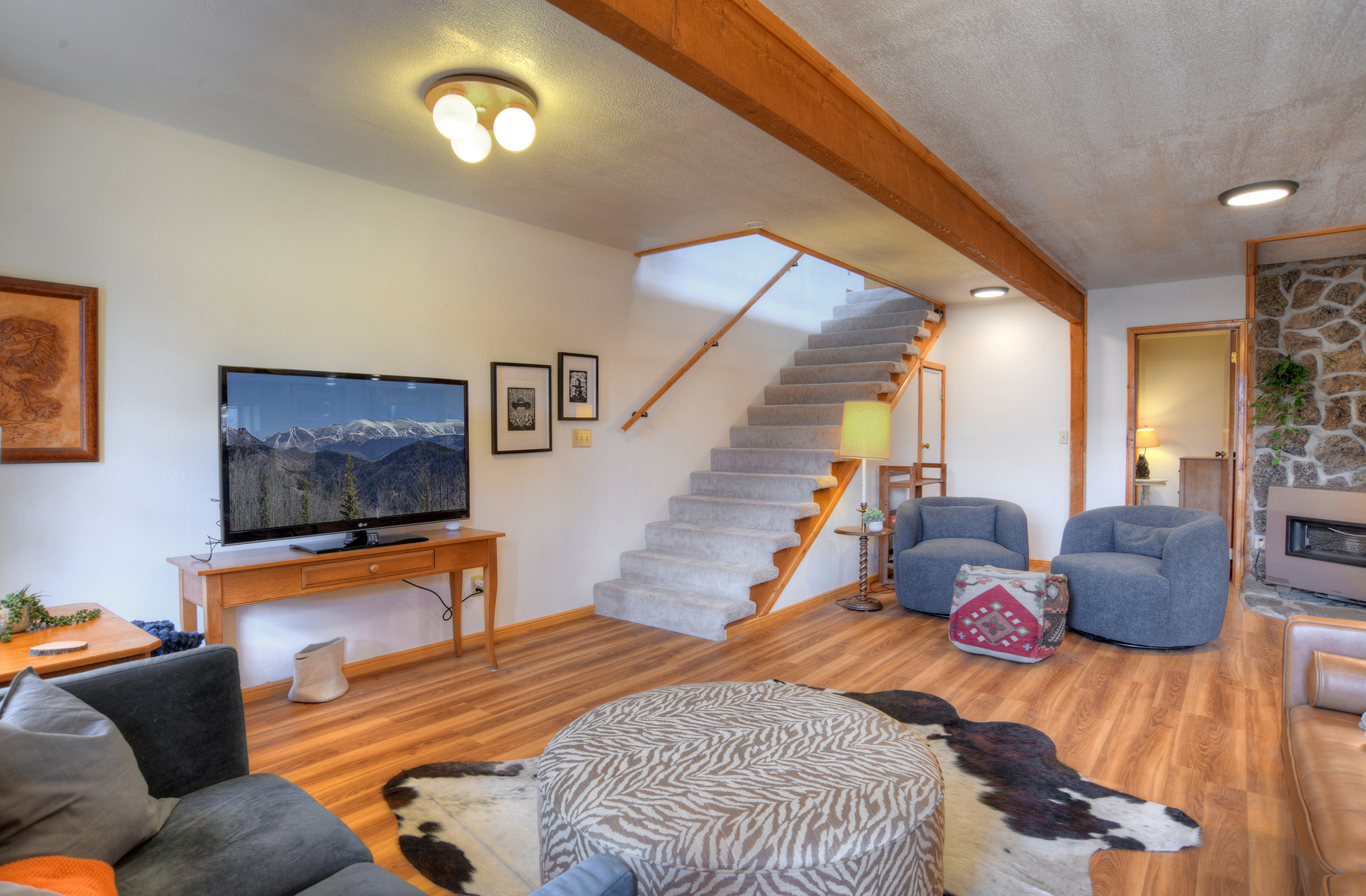 Living room with Smart TV. The stairs will take you upstairs to the king bedroom and second living room. 