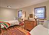 Fourth bedroom on the main level featuring two twin beds.