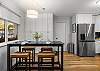 The spacious kitchen includes high top seating for 4. 