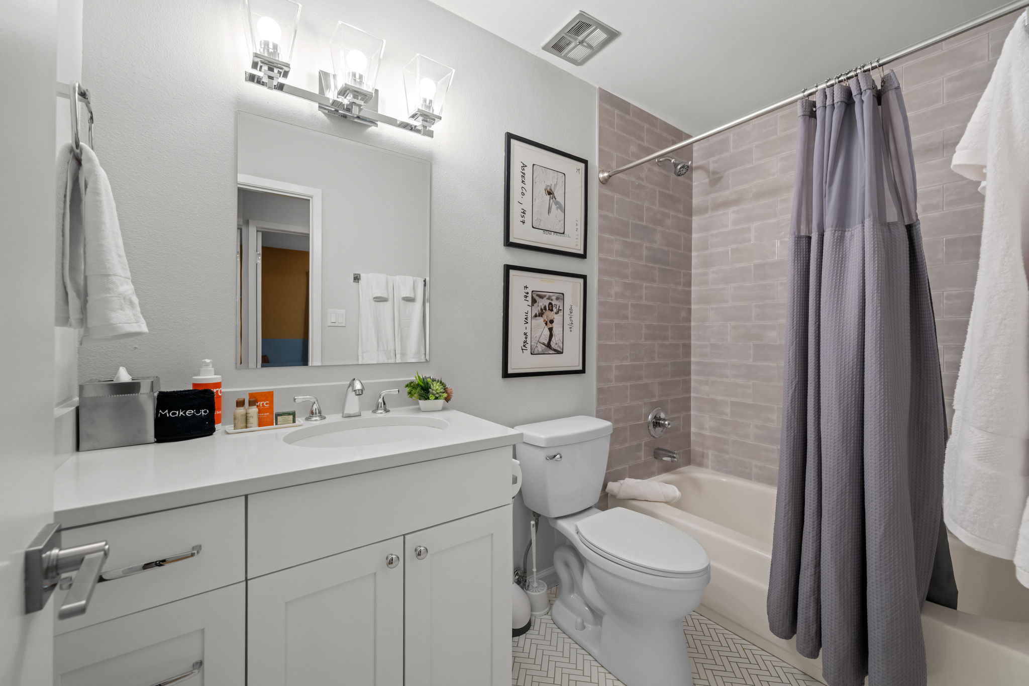 Full bathroom with convenient tub/shower combo and modern finishes.