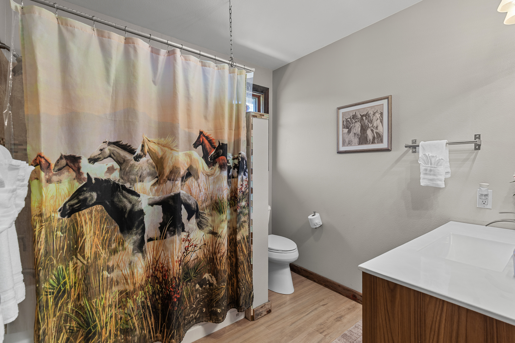 Spacious bathroom with tub and shower combo for added flexibility.