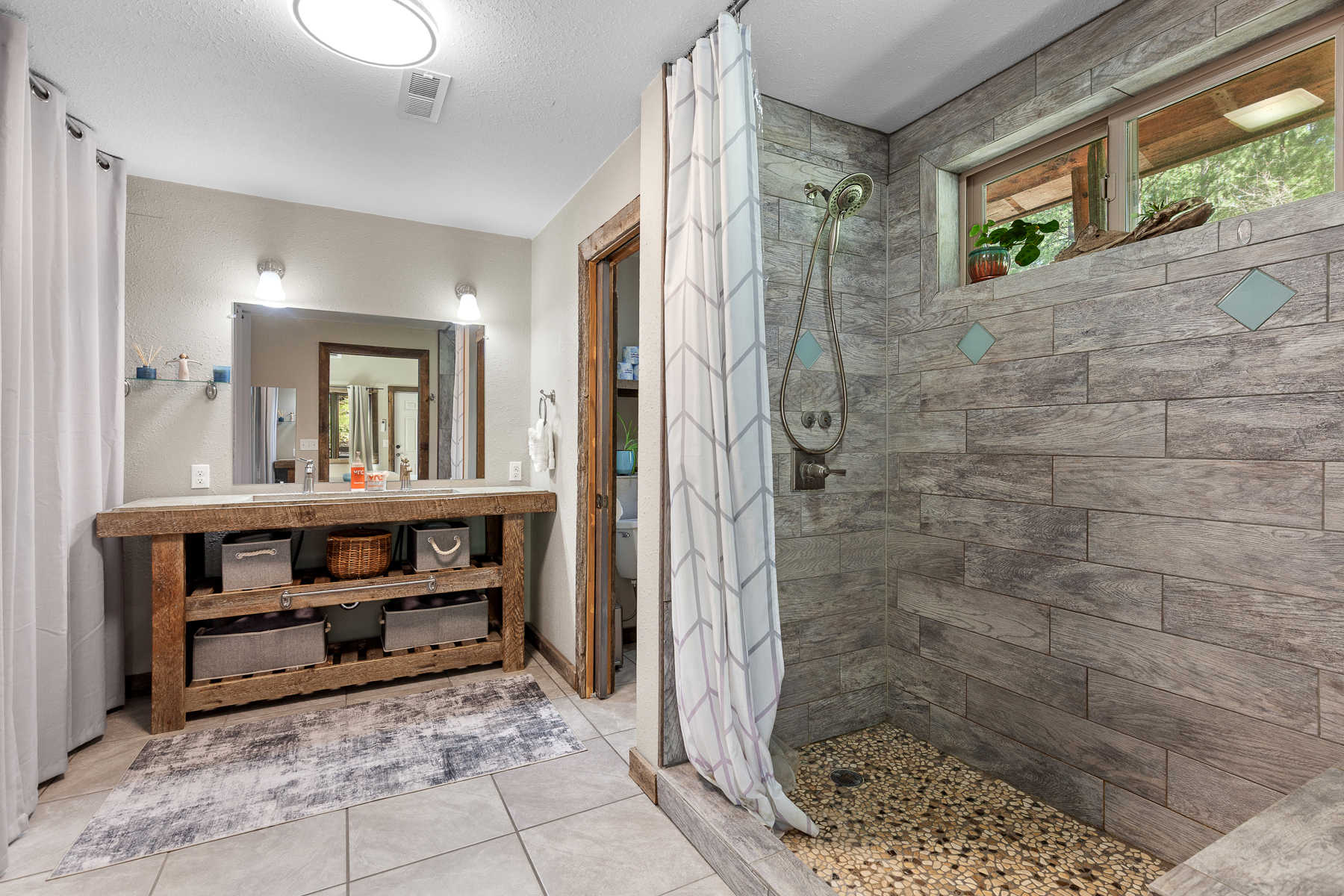 Full private bathroom as part of primary king bedroom. Features a sleek walk-in shower.