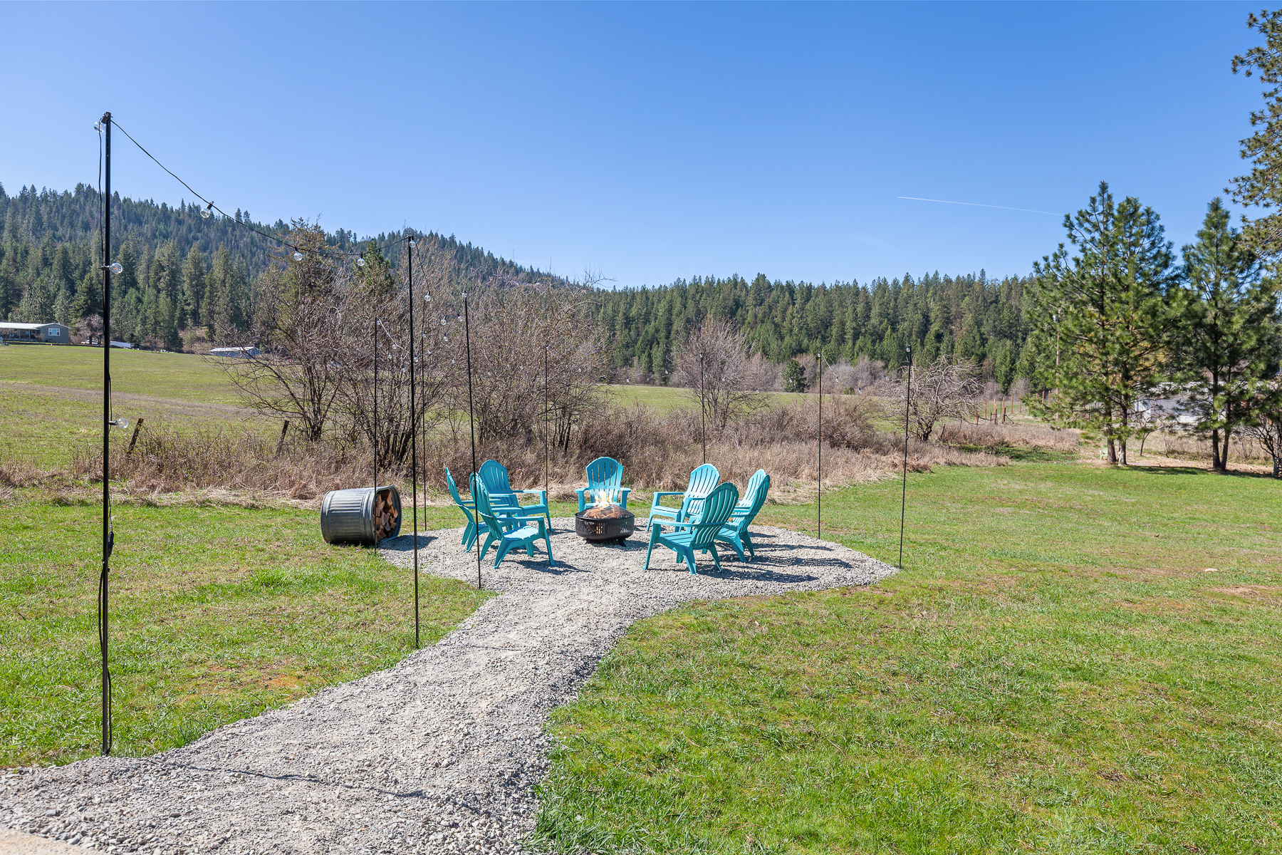 Enjoy an expansive backyard with a cozy firepit and sweeping views—perfect for relaxing evenings under the open sky.