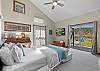 Bright queen room on the main floor with convenient patio access.