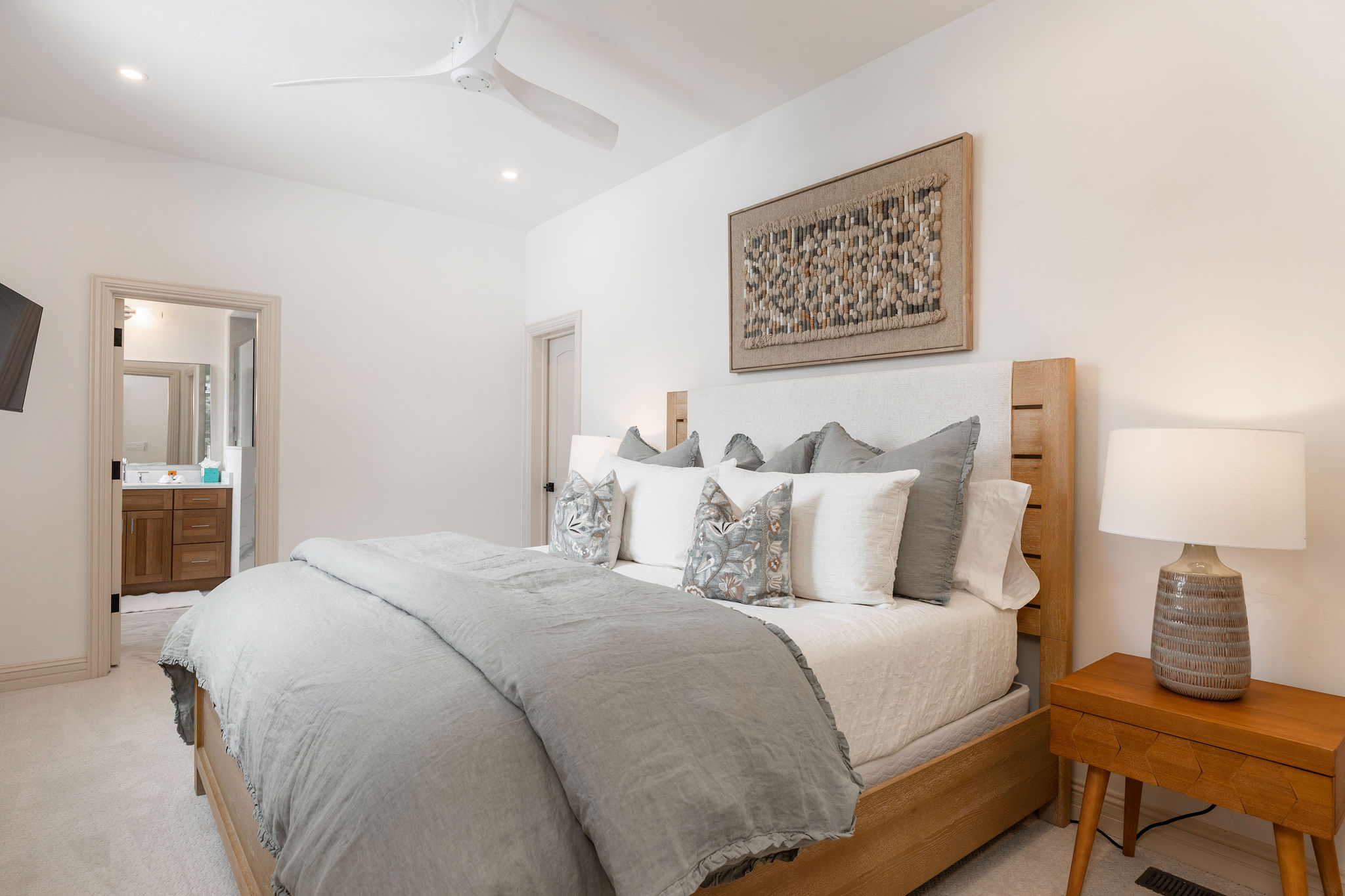 The primary suite located on the main level offers a serene retreat with its own en-suite bath and an attached study 