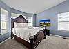 Unwind in this spacious queen bedroom with a Smart TV—comfort and entertainment in one.