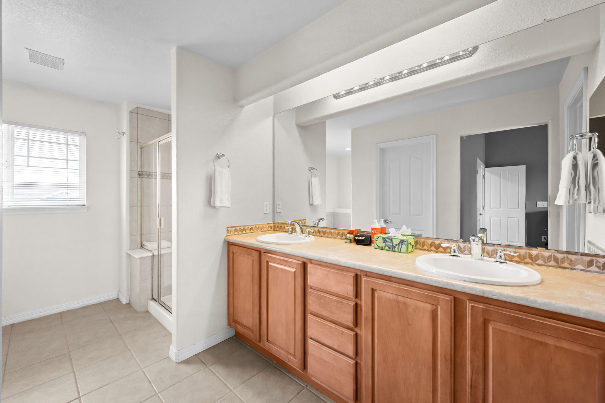 Spacious ensuite bathroom with dual vanity and walk-in shower.