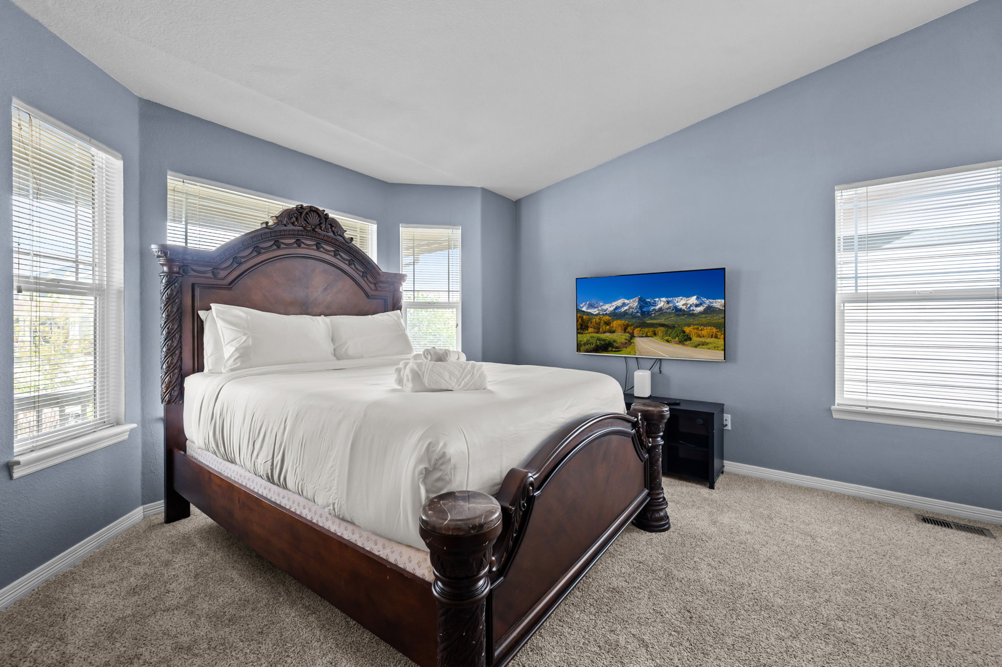 Unwind in this spacious queen bedroom with a Smart TV—comfort and entertainment in one.