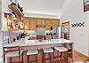 The island seats four and is perfect for casual meals, morning coffee, or keeping the cook company.