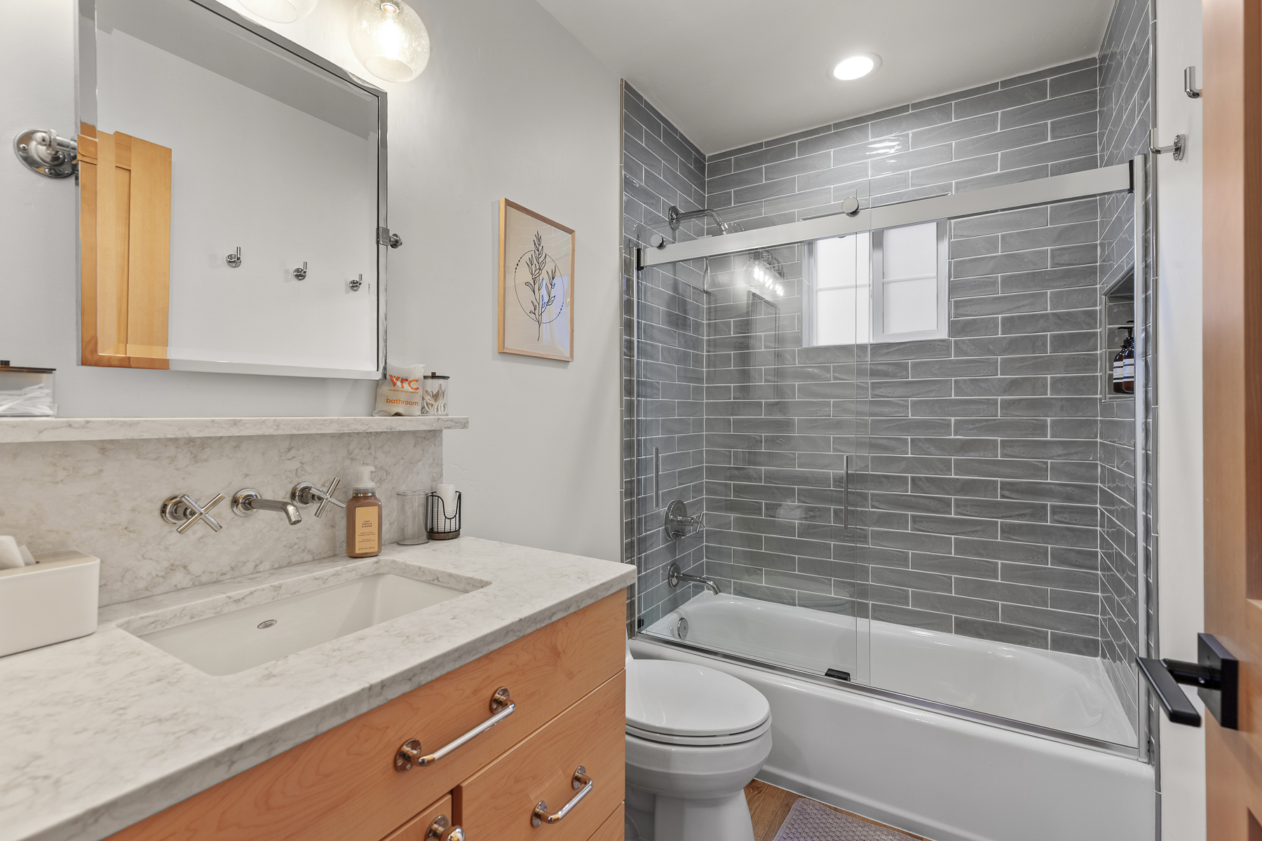 Full bathroom with convenient tub/shower combo and modern finishes.