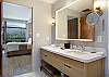 Full bathroom featuring a double vanity, large mirror, and a sleek walk-in shower.
