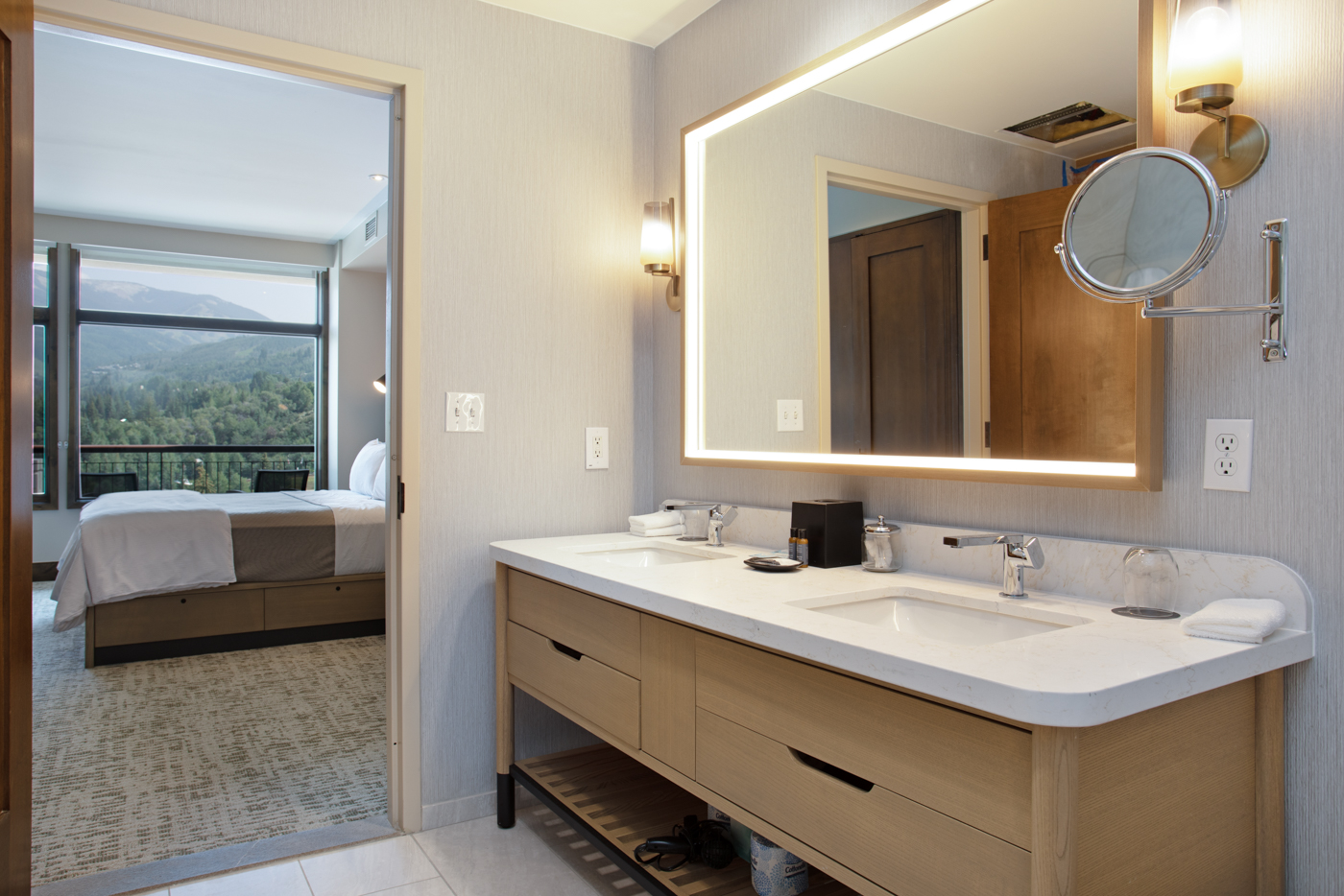 Full bathroom featuring a double vanity, large mirror, and a sleek walk-in shower.