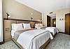 Bright and clean double-queen bedroom, perfect for a comfortable stay.