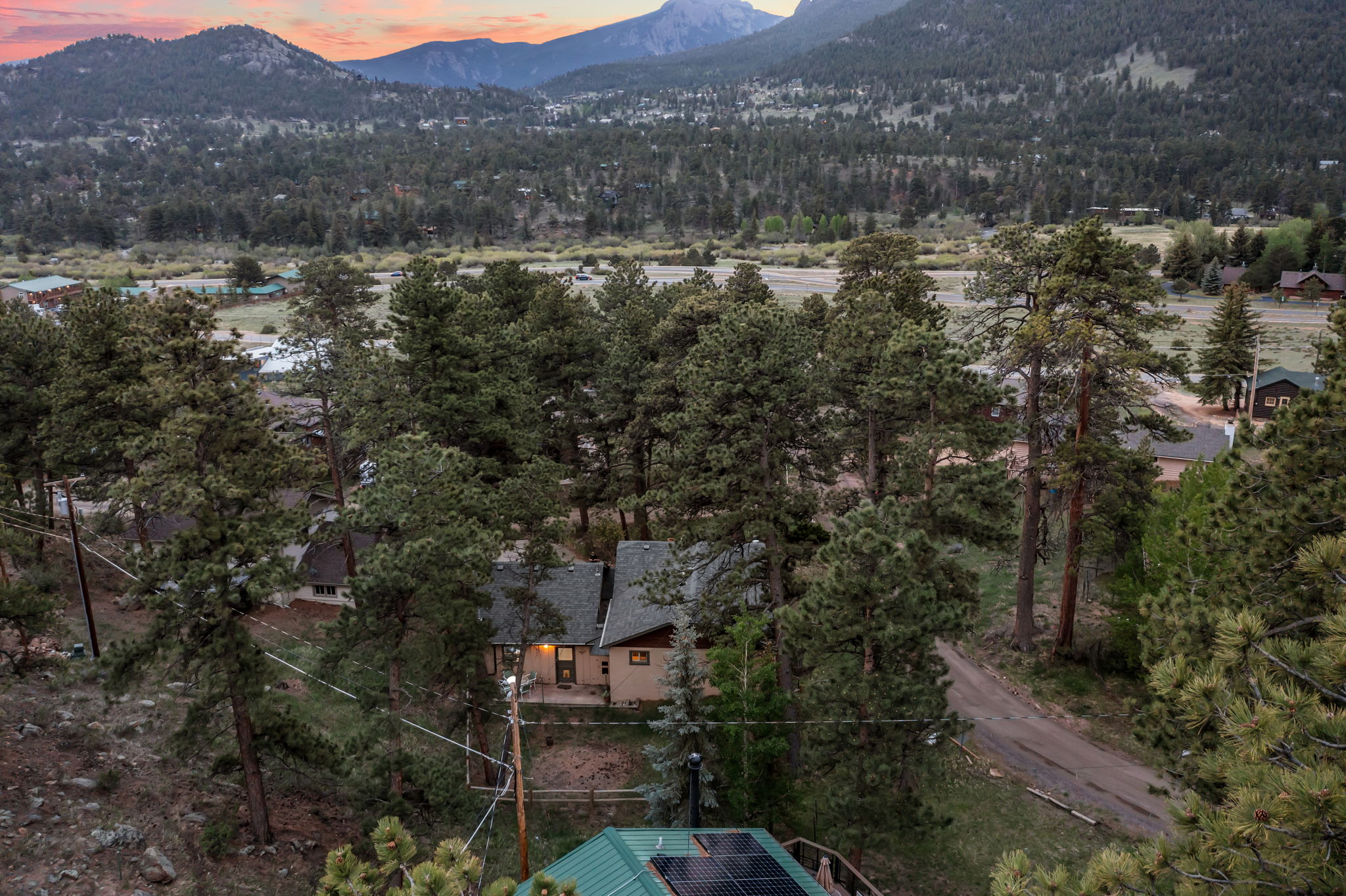 Tucked into the pines with a rocky peak as your backdrop — this is your home base for the mountains.