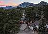 Tucked into the pines with a rocky peak as your backdrop — this is your home base for the mountains.