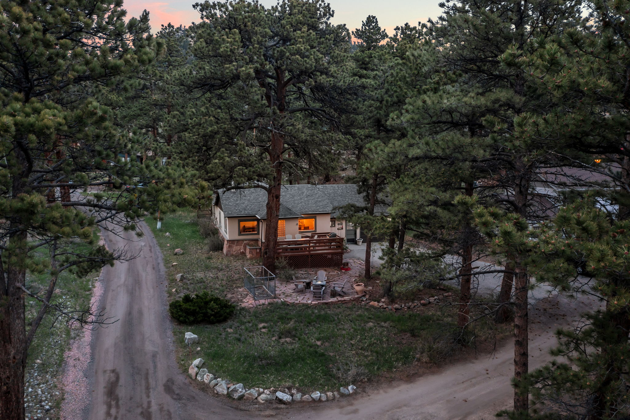 Tucked into the pines with a rocky peak as your backdrop — this is your home base for the mountains.