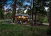 Tucked into the pines with a rocky peak as your backdrop — this is your home base for the mountains.