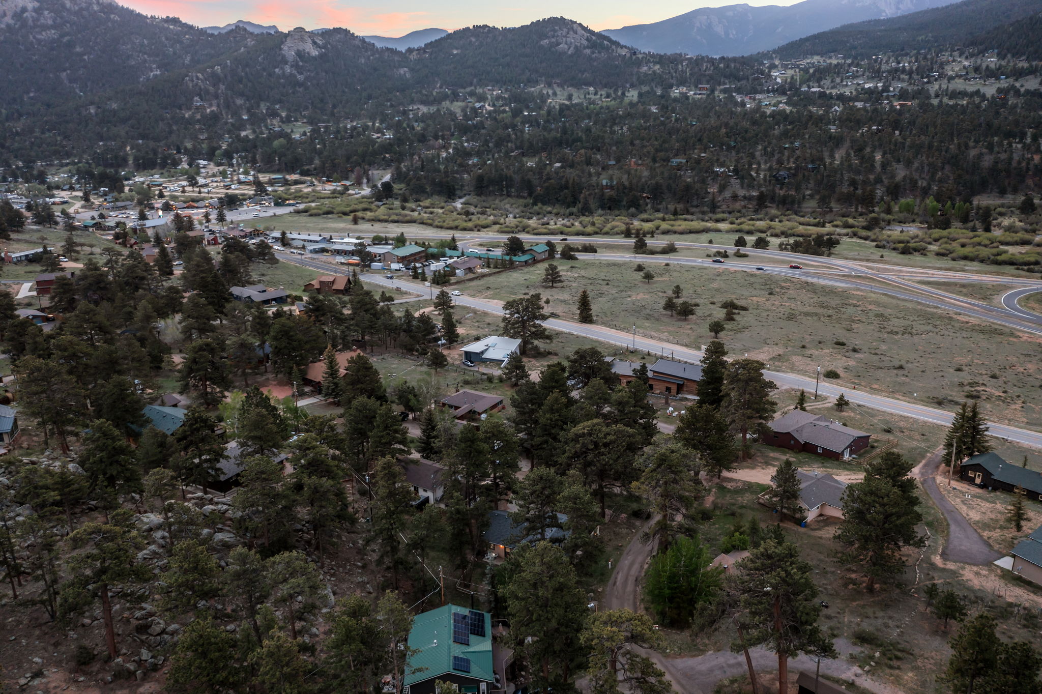Tucked into the pines with a rocky peak as your backdrop — this is your home base for the mountains.