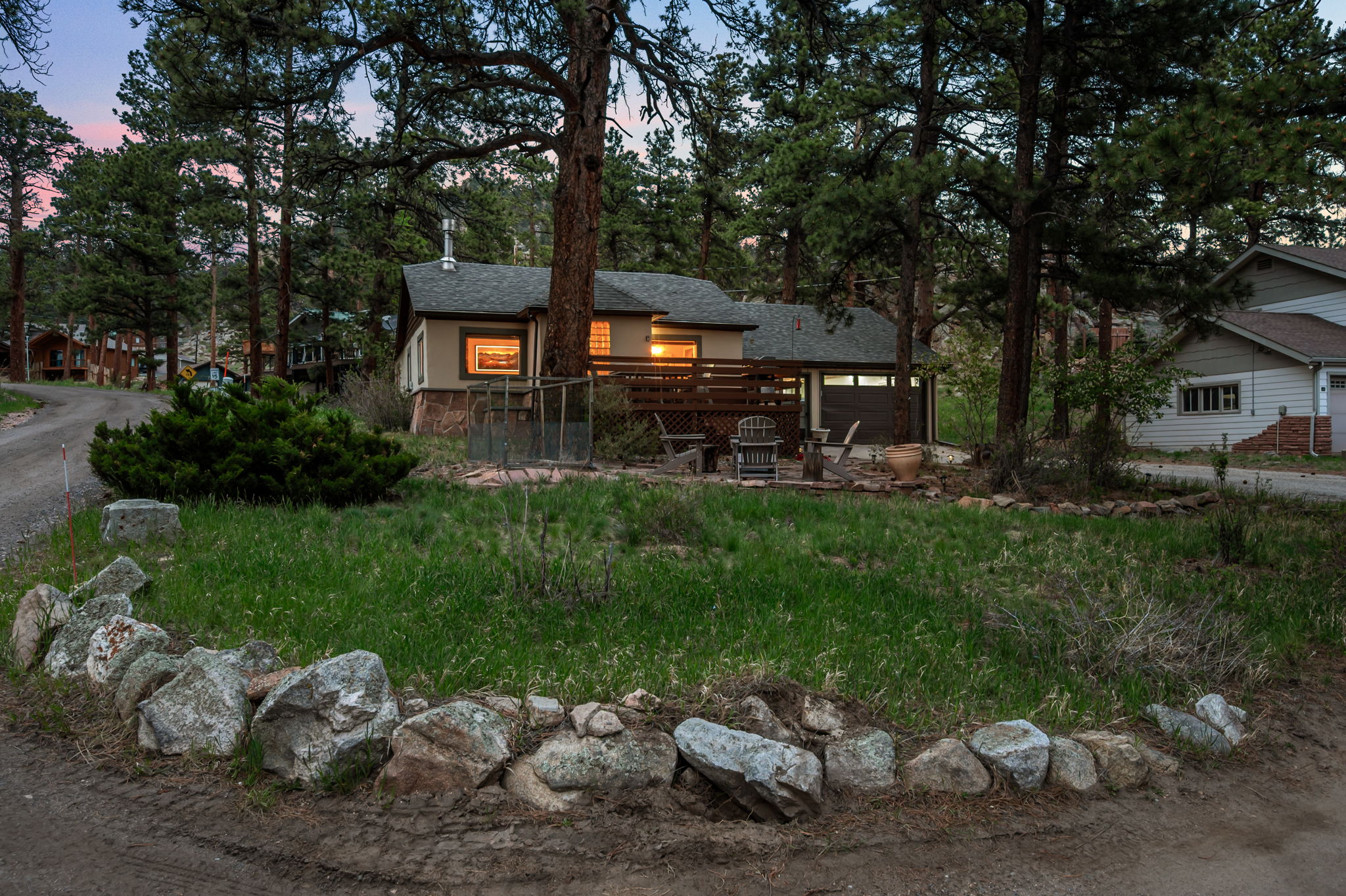 Tucked into the pines with a rocky peak as your backdrop — this is your home base for the mountains.