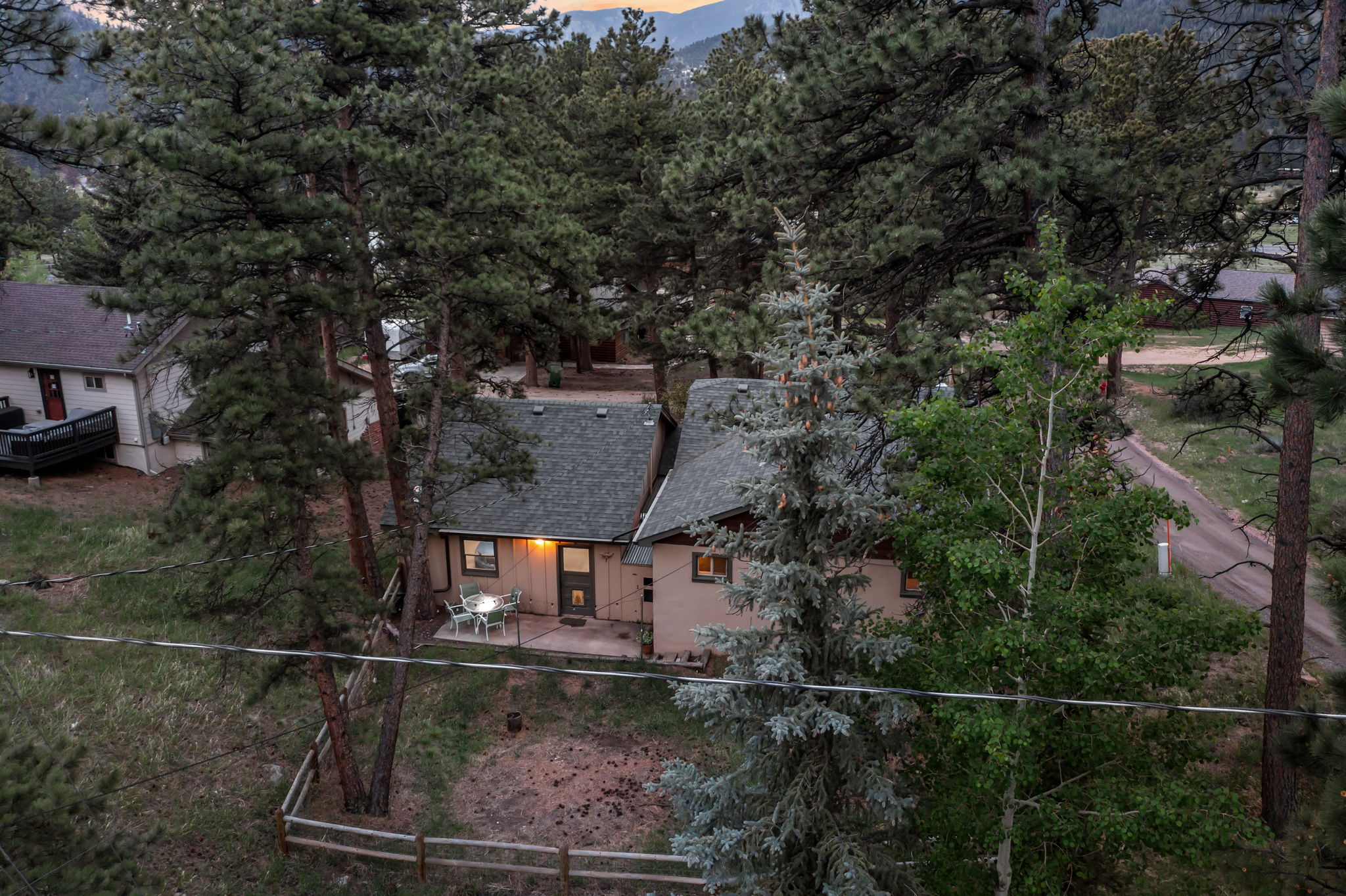 Tucked into the pines with a rocky peak as your backdrop — this is your home base for the mountains.