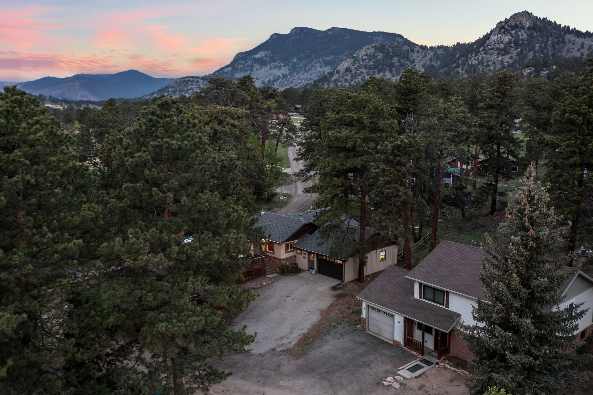 Tucked into the pines with a rocky peak as your backdrop — this is your home base for the mountains.