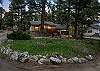 Tucked into the pines with a rocky peak as your backdrop — this is your home base for the mountains.