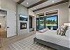 Wake up to sweeping Tanager Lake views — the primary suite features a king bed, gas fireplace, private patio access, and a spa-like ensuite with soaking tub, dual-head tiled shower, and walk-in closet.